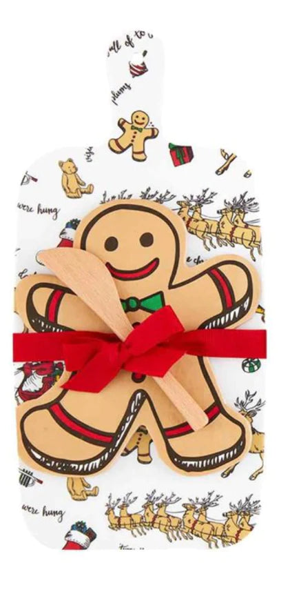 Christmas Melamine Board and Napkin Set including a rectangular reindeer-patterned paddle board, gingerbread man-shaped plate, and wooden spreader.