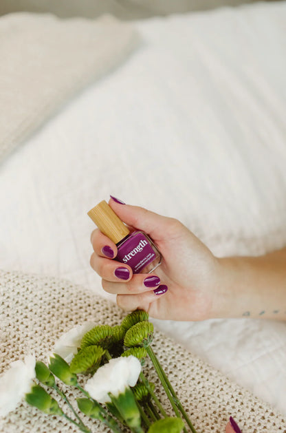 'Strength' violet purple nail polish bottle; concise, vibrant color. Sizes: 10ml, 15ml.