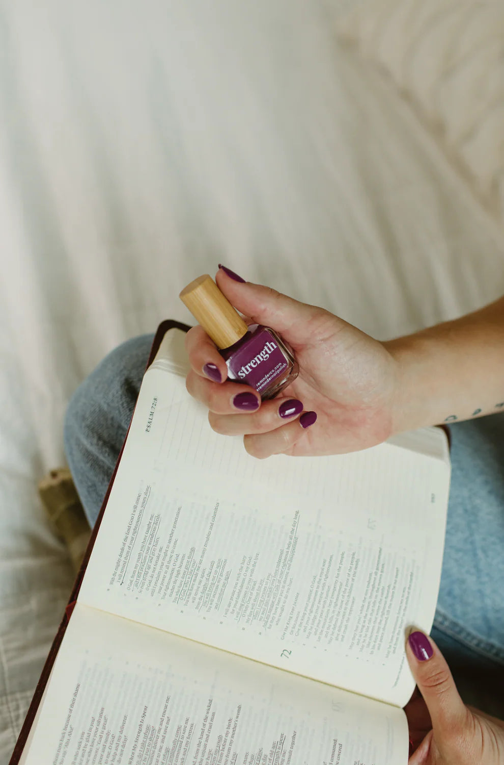 A bottle of 'strength' violet purple vegan nail polish shown; available in 10ml and 15ml sizes.
