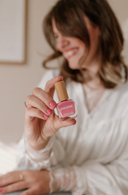 ‘Purpose’ honeysuckle pink nail polish bottle shown; available in 10ml and 15ml sizes.