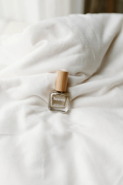 Small glass bottle of ‘heaven’ shiny gold reminder nail polish with wooden cap; available in 10ml and 15ml sizes.