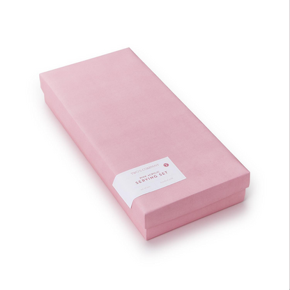 A light pink closed rectangular gift box labeled "Pink Blush Set of 2 Servers." Made of acrylic stainless steel. Available sizes: Not specified.