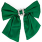 The Holiday Bow: Large green satin bow with a circular cluster of small silver rhinestones at the center; features two long, loose tails. Available in one size.
