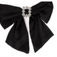The Holiday Bows: Black satin-like bow with a silver-colored brooch encrusted with small, sparkling gems. Features two long tails. Sizes: N/A.