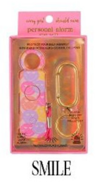 Simply Southern Personal Alarm: Pink package. Contains keychain alarm, vibrant pom-pom, whistle, and gold carabiner. "SMILE" printed at the bottom. Sizes: One size only.