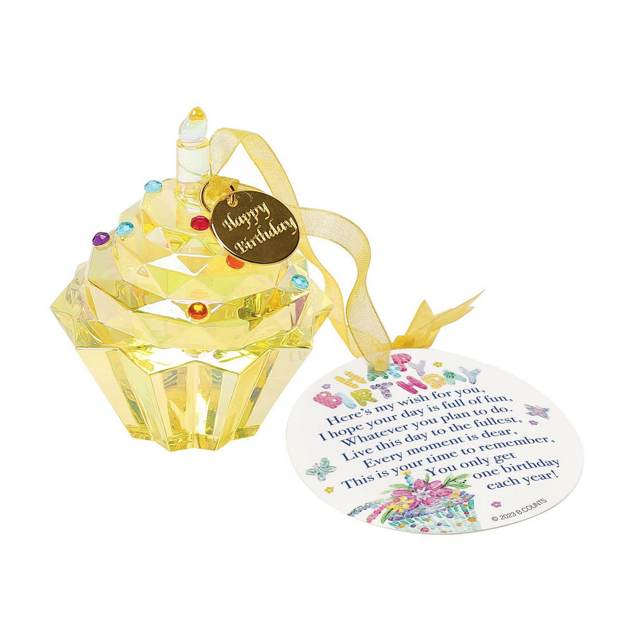 The Happy Birthday Cupcake Ornament is a decorative yellow crystal figurine shaped like a cupcake, featuring a candle and "Happy Birthday" tag. Part of Enesco's Facet Collection, it includes colorful gem accents. It comes attached to a circular card with illustrations of balloons and confetti. Suitable for gifting. Size: 3 inches tall.
