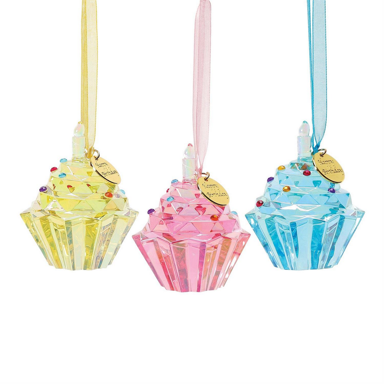 Three decorative Happy Birthday Cupcake Ornaments from Enesco's Facet Collection. Made of faceted crystal with colorful sprinkles, topped with a ribbon for hanging and gold tags. Available in pastel yellow, pink, and blue. Sizes: N/A.