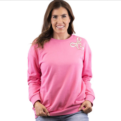 Pink Bow Sequin Sweatshirt: Bright pink, long-sleeved cozy top with embroidered design near left shoulder. Available sizes: S, M, L, XL.