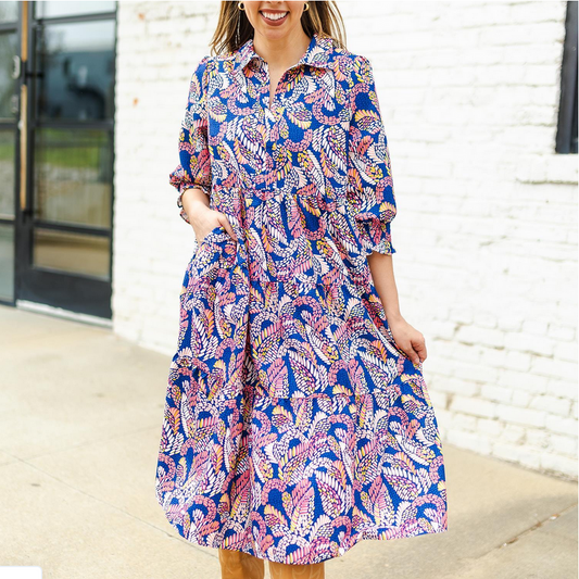 Eleanor Dress: long, collared, with pockets; blue with pink, yellow, and white leaf print. Available in sizes XS-XL.