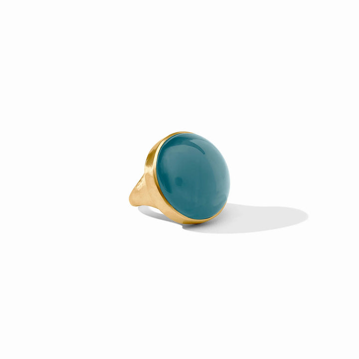 24K gold plated Solara Statement Ring with a round iridescent Montana Blue stone. Available in sizes 6, 7, and 8.