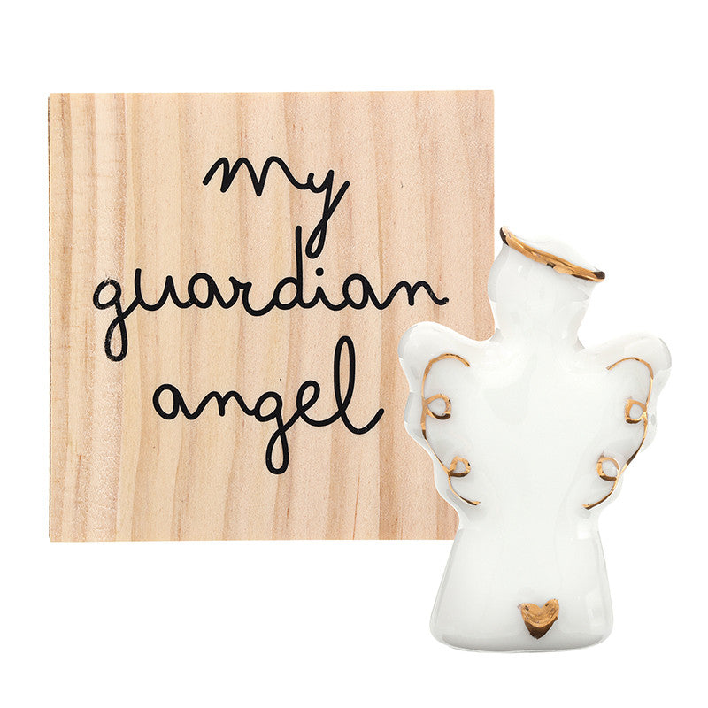 Small ceramic angel figurine with gold accents, next to a wooden sign reading “my guardian angel” in black cursive. Available sizes: [sizes not specified].