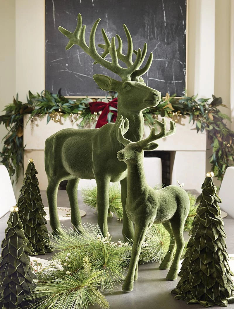 Two 32″ Forest Green flocked reindeer figurines.