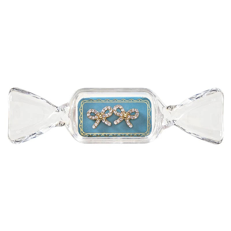 Sweet &amp; Sparkly rhinestone bow stud earrings in a candy-shaped container.