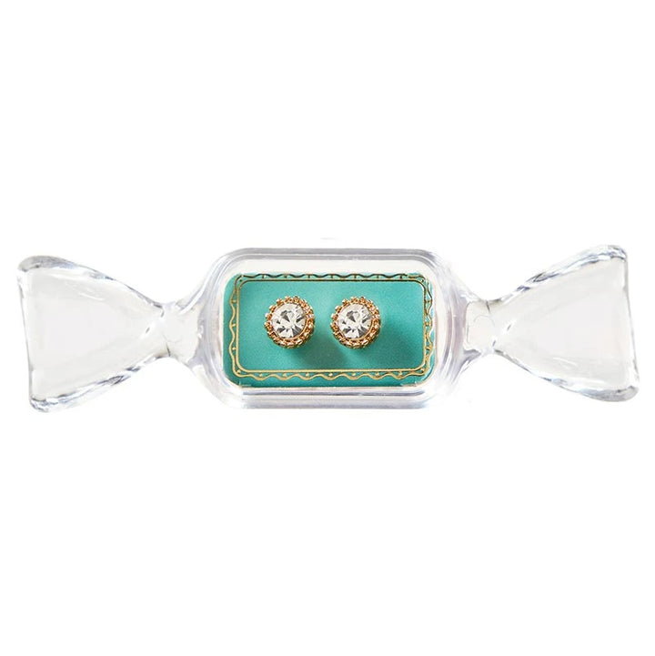 Round gold stud earrings with clear crystals in a candy-shaped display case.
