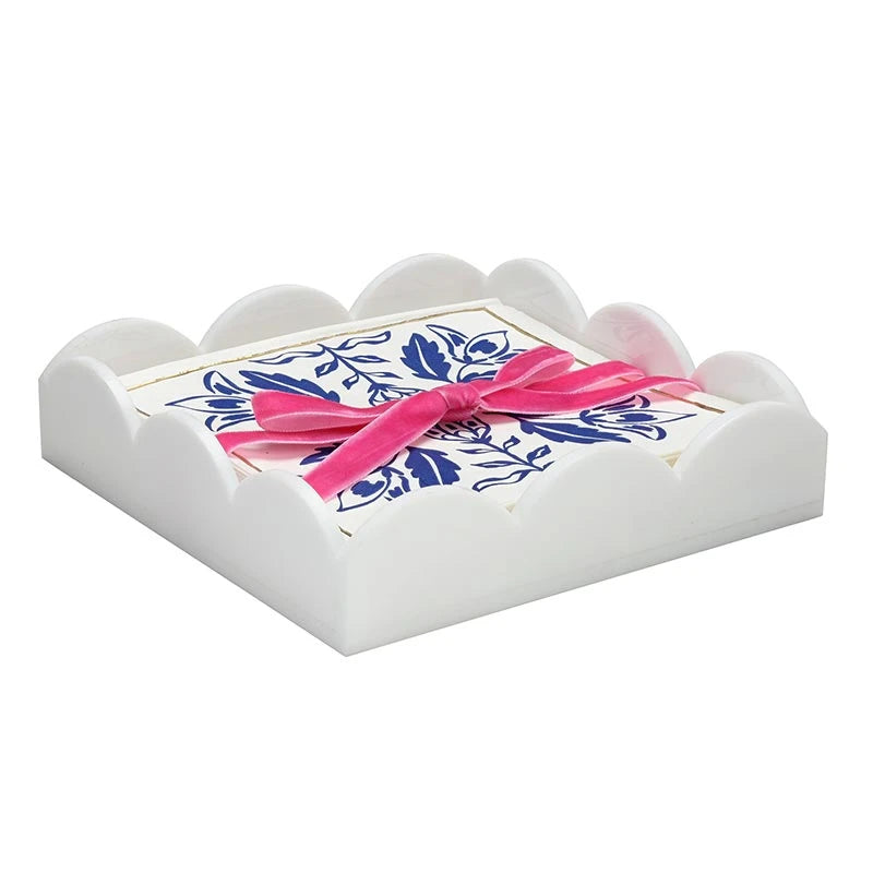 Acrylic cocktail napkin tray in Damask pattern with white scalloped-edge design, includes floral napkins tied with a pink ribbon. Available in standard cocktail napkin size.