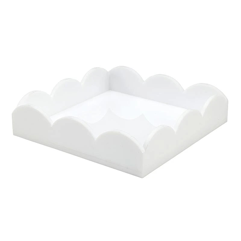 White acrylic cocktail napkin tray with scalloped, wavy sides and sleek interior; available in standard cocktail napkin size.