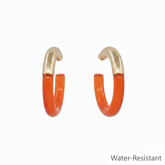 Teo Resin & Gold Hoop Earrings with orange resin lower halves and textured gold upper halves, water-resistant. Sizes available: S, M, L.