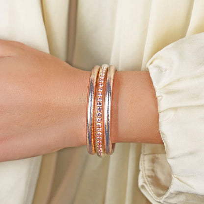 The Champagne Queen Stack is a waterproof silver bangle with pink and clear gemstones. Available in S, M, L.