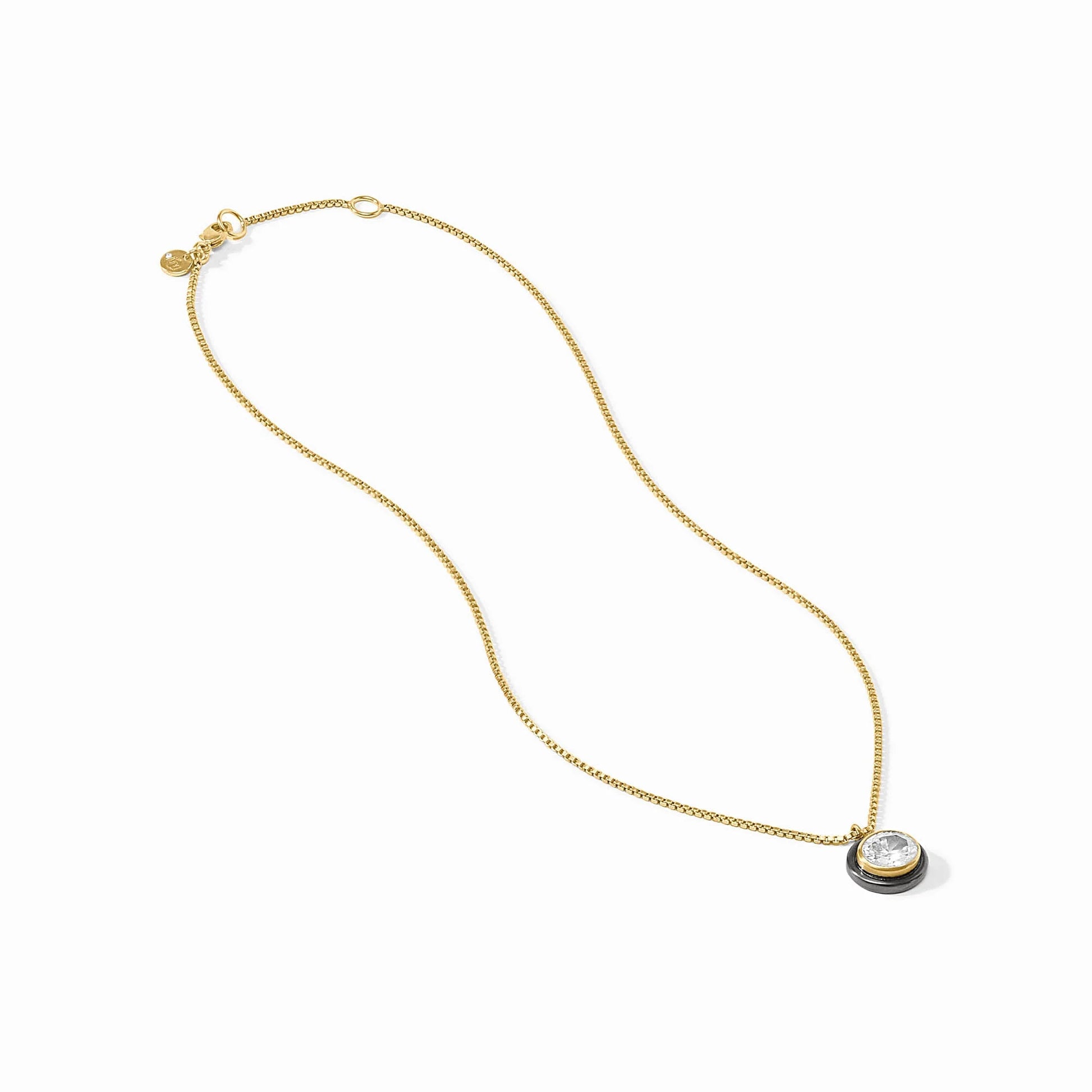 Gold-plated Tribeca Delicate Necklace with round bezel-set cubic zirconia pendant and small gold tag by the clasp. Sizes: 16", 18".