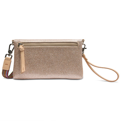 The Emery Uptown Crossbody is a glittery gold clutch with a wristlet strap, card holder slots, and a decorative zipper pocket. It includes a detachable multicolored shoulder strap for crossbody use. Available sizes: One Size.