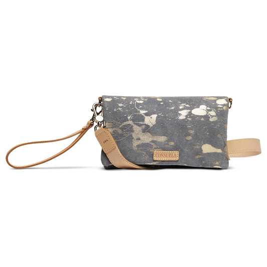 Small gray Uptown Crossbody, Jagger, with gold splatter design, tan leather wristlet strap, and front tan leather Consuela patch. Available in one compact size.