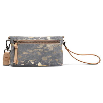 Small gray crossbody with gold splatter pattern, front zipper pocket, tan leather wristlet strap, and leather zipper pull. Available in one size.