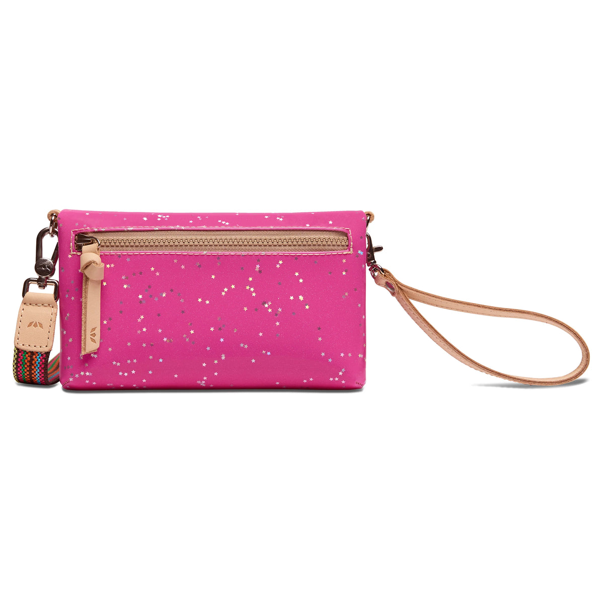 The Uptown Crossbody, Berry, has a bright pink design with white speckles, tan zipper, leather wrist strap, and small multicolored accent strap on the left. Features secure zipper compartments. Available sizes: small and medium.