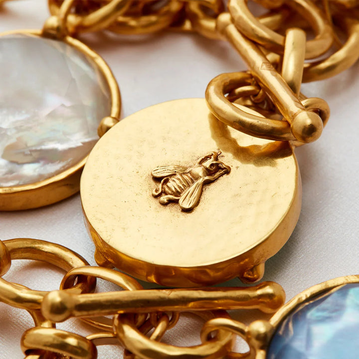 Gold-tone Iridescent Tourmaline Pink Honeybee statement necklace with circular charms, featuring an embossed honeybee and iridescent stone settings.