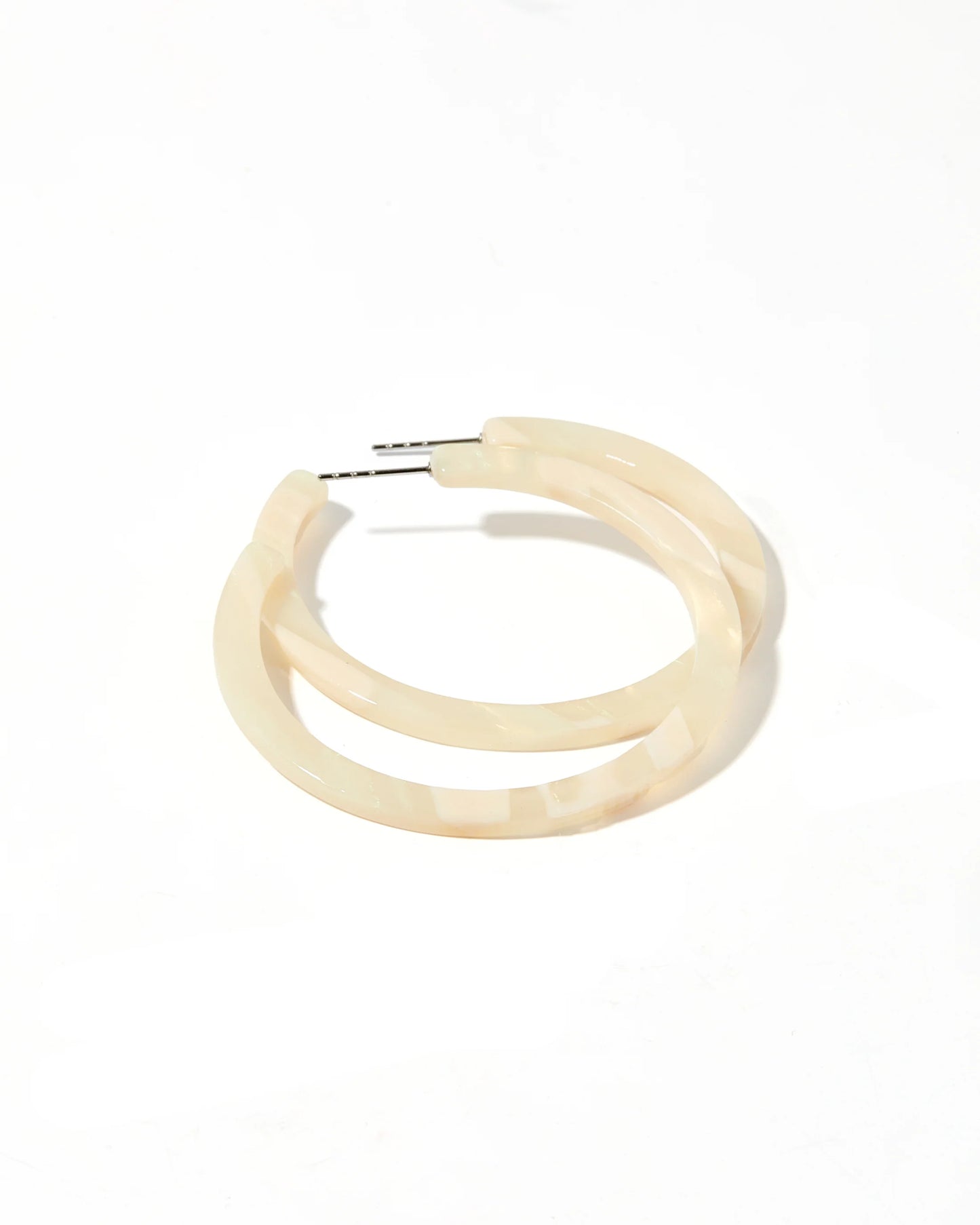 Cream-colored, semi-translucent hoop earring with silver surgical steel post. Available in small and medium sizes.