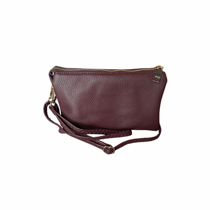 The Riley Crossbody Bag in maroon textured vegan leather with gold zipper, detachable strap; available in small and medium sizes.