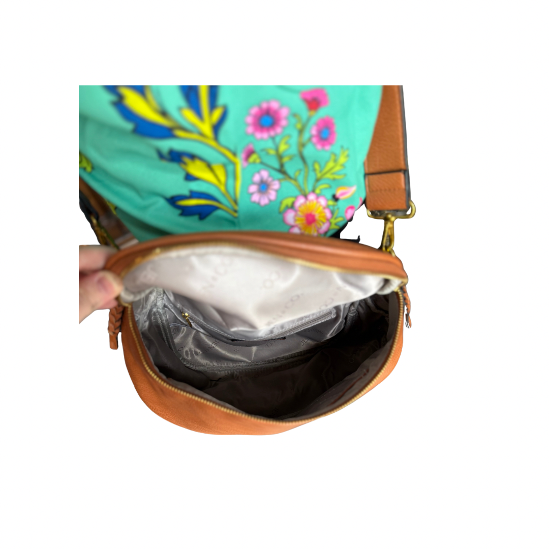Brown vegan leather Megan Sling Bag with light inner lining. Available in small, medium, and large sizes.