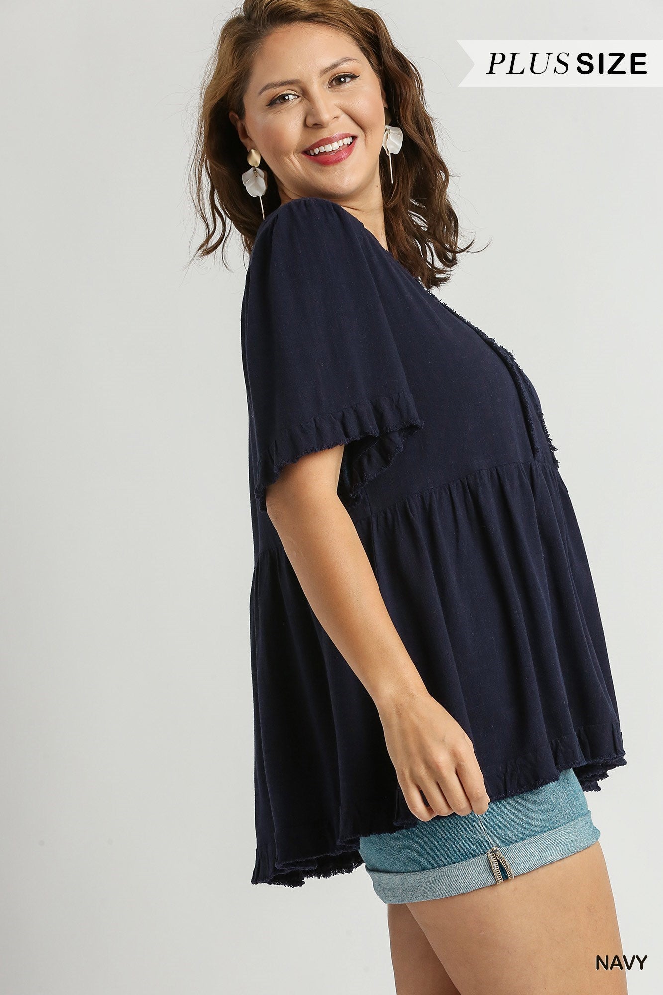 This is a Linen V-Neck Pleated Top featuring Ruffle Sleeves & Fray Details. Available in all sizes.