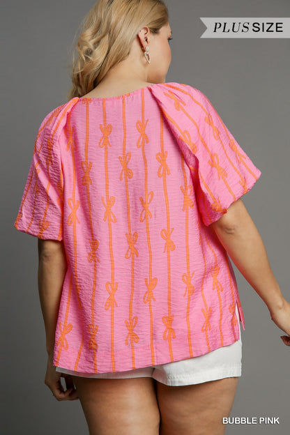 Pink Ribbon Print Puff Sleeve Top. Features trendy puff sleeves and orange bow patterns. Available in sizes XL to 4XL.