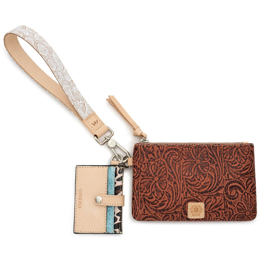Combi, Sally wristlet wallet with tan strap, brown leather pouch featuring floral patterns, and cardholder with beige, turquoise, and animal print accents secured by a metal clasp. Available in multiple sizes.
