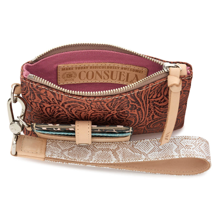 Brown floral zippered wristlet wallet with tan leather strap, pink interior with motivational label, and small loop for a patterned pen. Sizes available: not specified.
