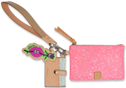 Pink speckled wristlet wallet with neon pink star glitter, tan strap, tan and mint card slot wallet, and keychain featuring a cartoon mouth with green lips and white teeth. Available sizes: One size.