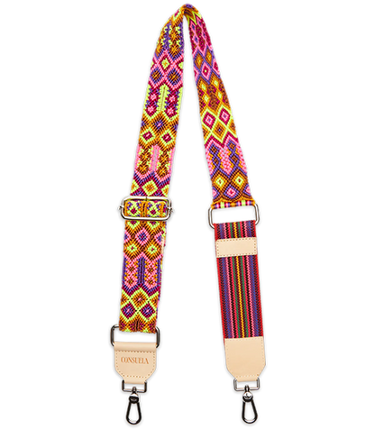 The Consuela Woven Crossbody Strap, Bubbles, features vibrant geometric patterns in pink, yellow, and orange. It has metal clips at each end and a beige leather patch with text. Adjustable length for customizable fit.