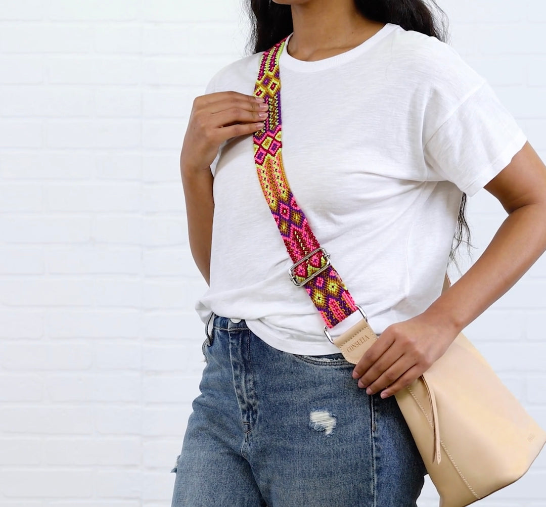 The Consuela Woven Crossbody Strap in Bubbles features a colorful, vibrant design. Available sizes: Adjustable length.