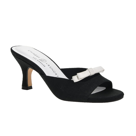 The Yolana Heel - Black/White is a black slip-on shoe with an open toe and medium slim heel, adorned with a white decorative bow and branded insole. Available sizes: 5-11.