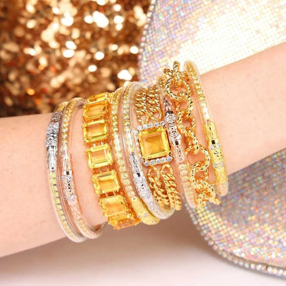 Three Queens All Weather Bangles in Yellow Rose, featuring yellow gemstones and fine-jewelry craftsmanship; available in small, medium, and large sizes.
