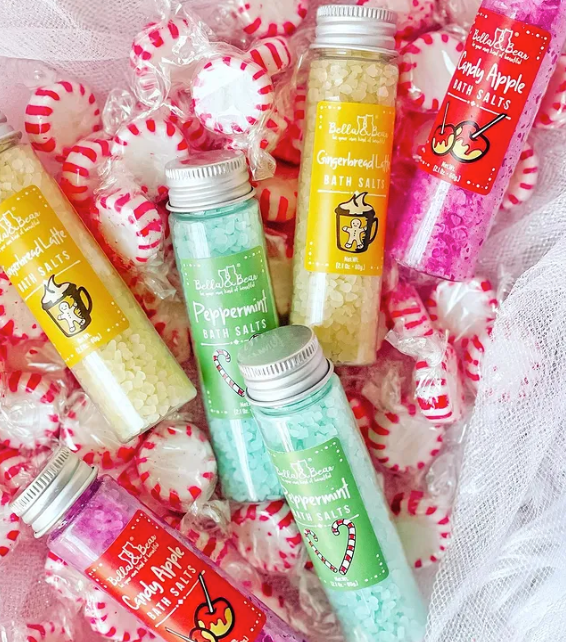 Five glass tubes of Candy Land Christmas Bath Salts in Gingerbread Latte, Peppermint, and Candy Apple scents.