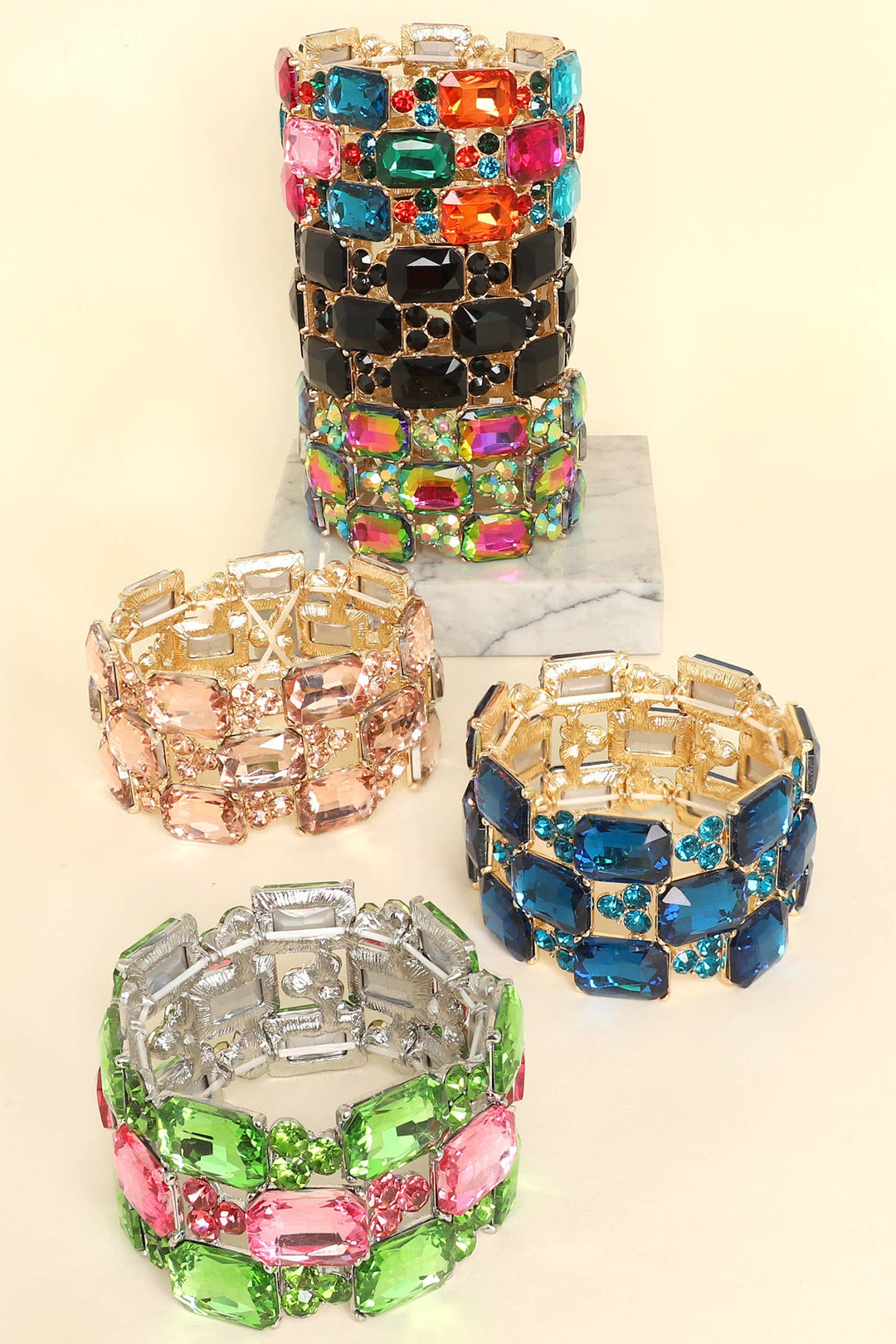 Five 3-row rectangle cut crystal gem cluster bracelets in black, pink, blue, green, and multicolor. Sizes available: S, M, L.