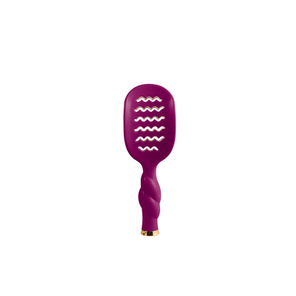 Compact, vibrant purple mini vented hair brush with twisted handle and wavy paddle slits for easy detangling. Available in mini size.