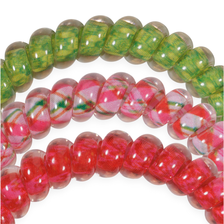 And to All a Good Night Small hair ties featuring three no-crease spiral coils in green plaid, pink plaid, and solid pink.