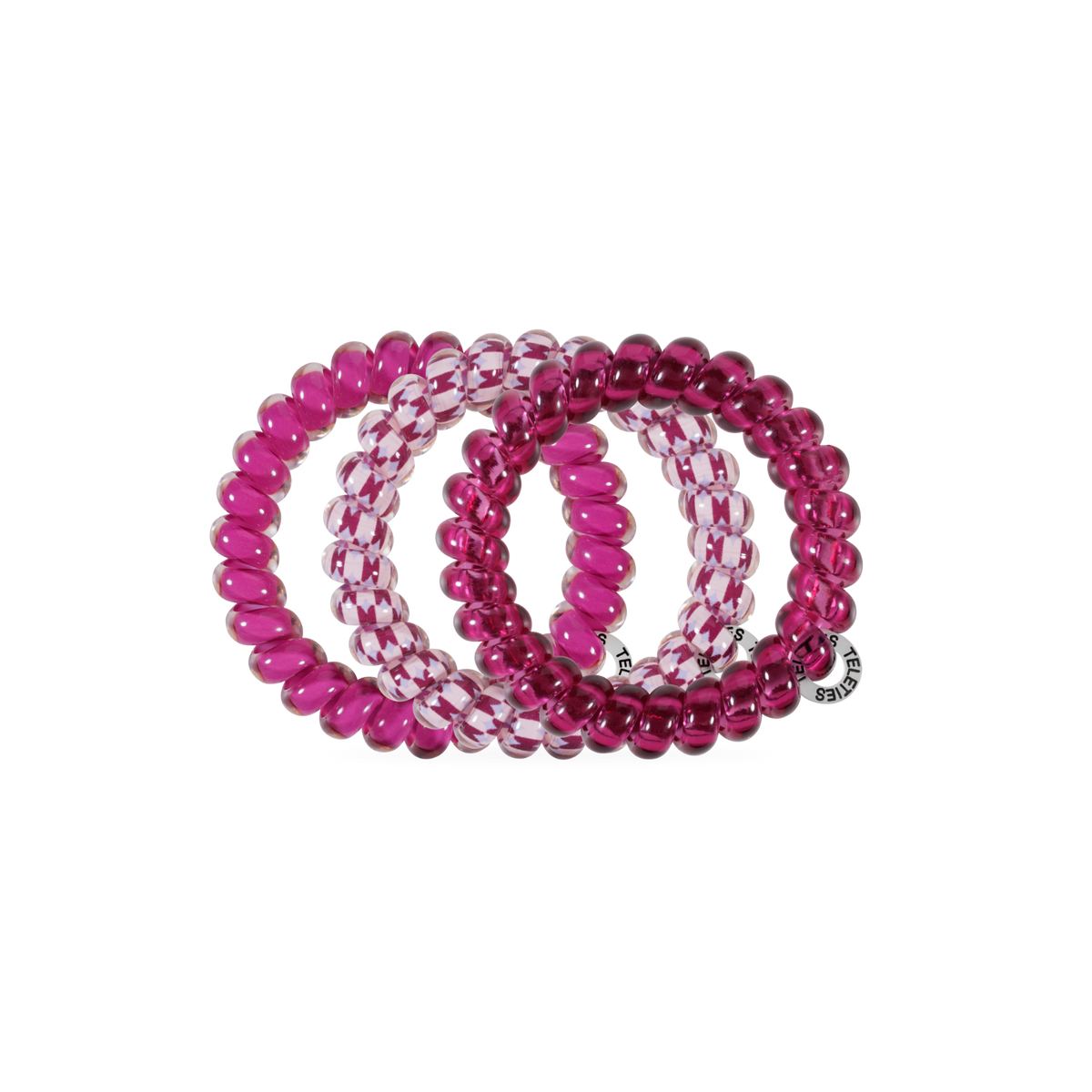 Three Merlot after Midnight Large Hair Ties in spiral coil designs—two pink, one clear with pink accents. All are no-crease; one features a small silver tag. Available in large size.