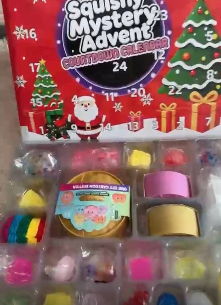 Open Squishy Mystery Calendar Countdown Days box containing small, individually packaged colorful squishy toys in a molded plastic tray.