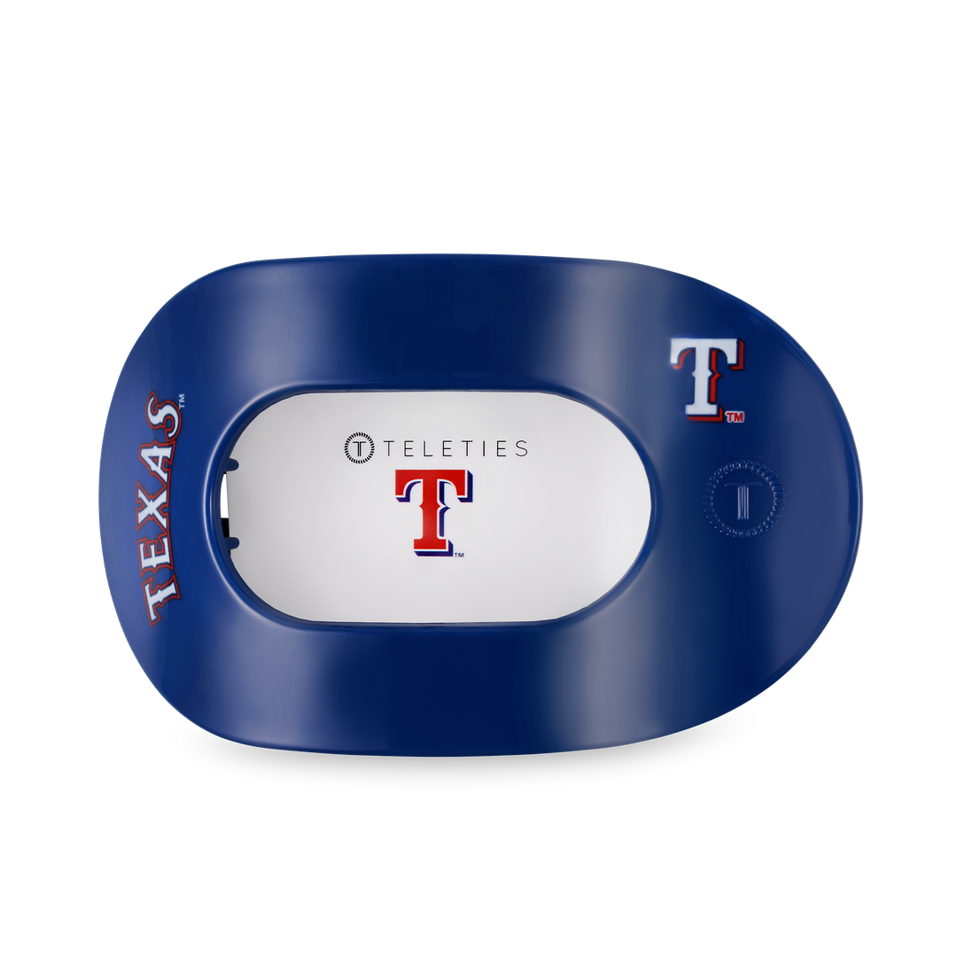 Navy blue round hair clip with Texas Rangers logo, "TEXAS" in red and white, white center labeled "TELETIES." Available in multiple sizes.