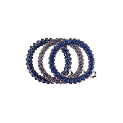 Three Twilight Tones Small Hair Ties in navy blue and clear, each with a round metallic charm. No-crease design. Available in small size.