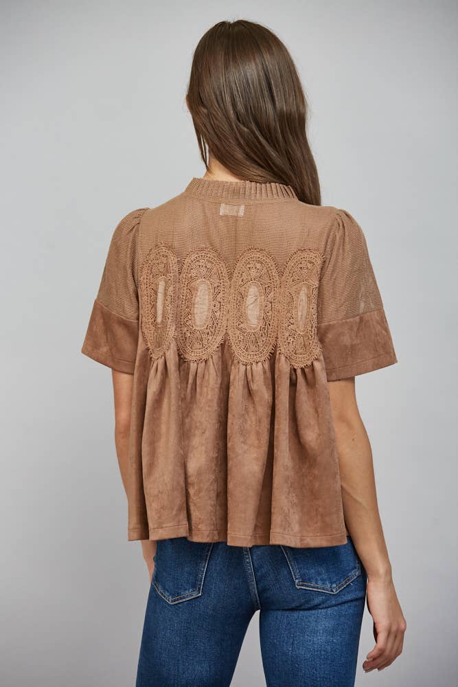 Teal blue short-sleeved faux suede top with sheer mesh upper, lace appliques on back, and flared hem. Available in multiple sizes.