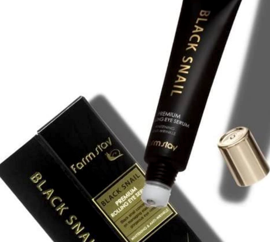 FARMSTAY Black Snail Premium Rolling Eye Serum tube with gold cap off; available in 25ml size.